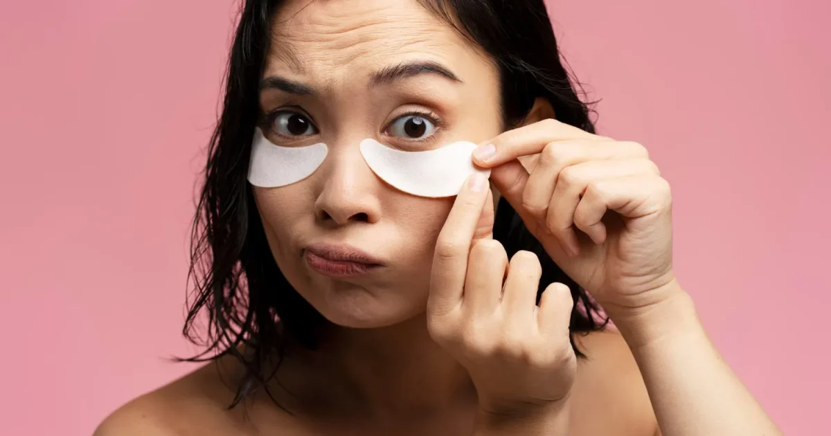 woman putting patches under her eyes