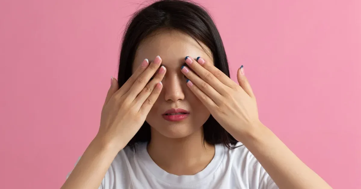 woman covering her eyes with her hands