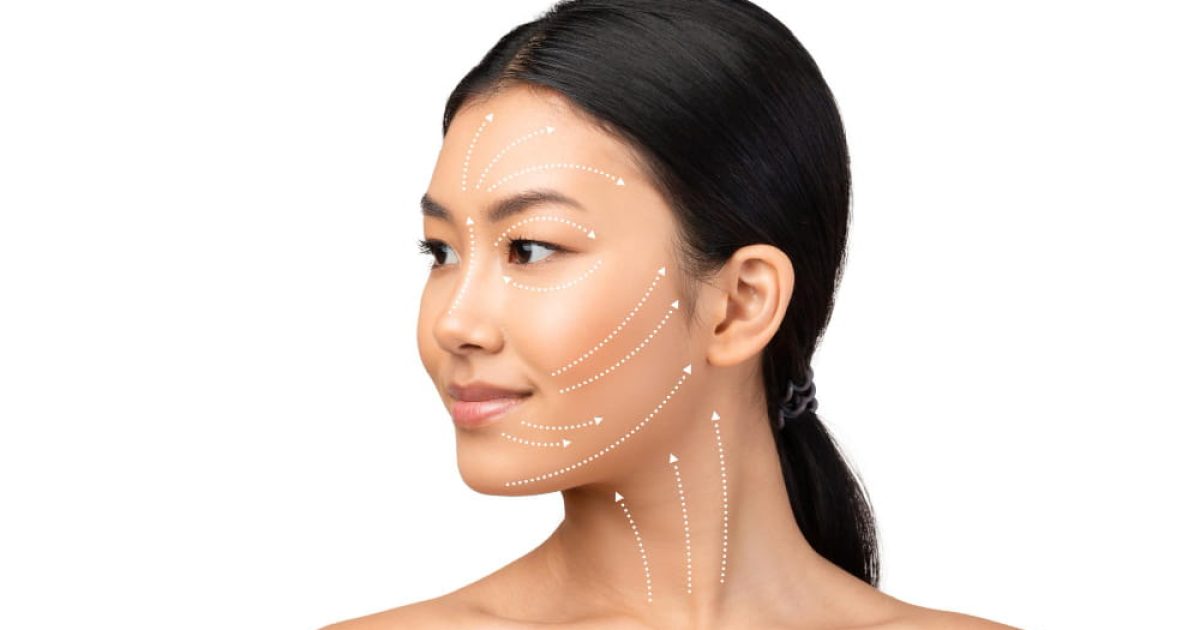 woman with glowing skin and dotted contour guide lines on her face and neck.